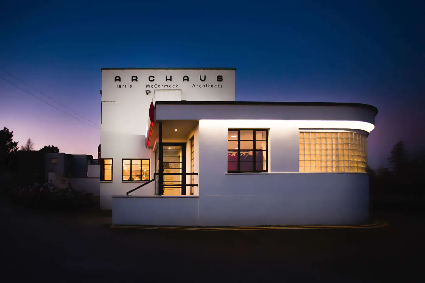 ArcHaus at dusk, its curved window glowing