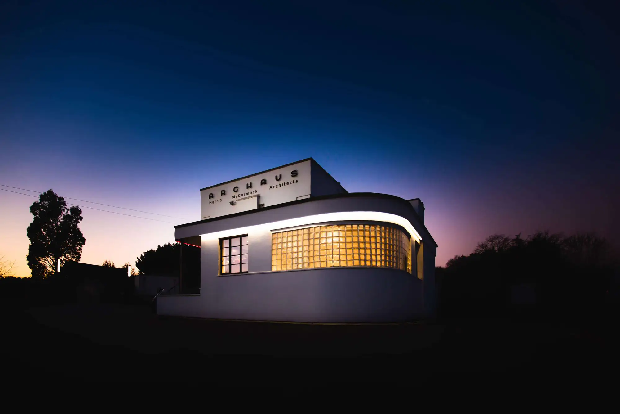 ArcHaus, Wansford: the practice’s own 1930s building lit at dusk