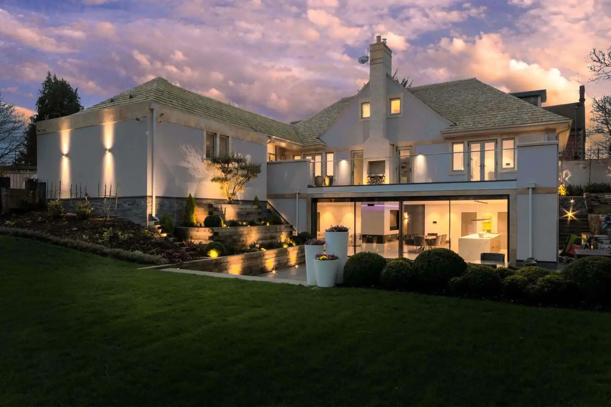 Holwell, Stamford: a new sustainable house lit at dusk