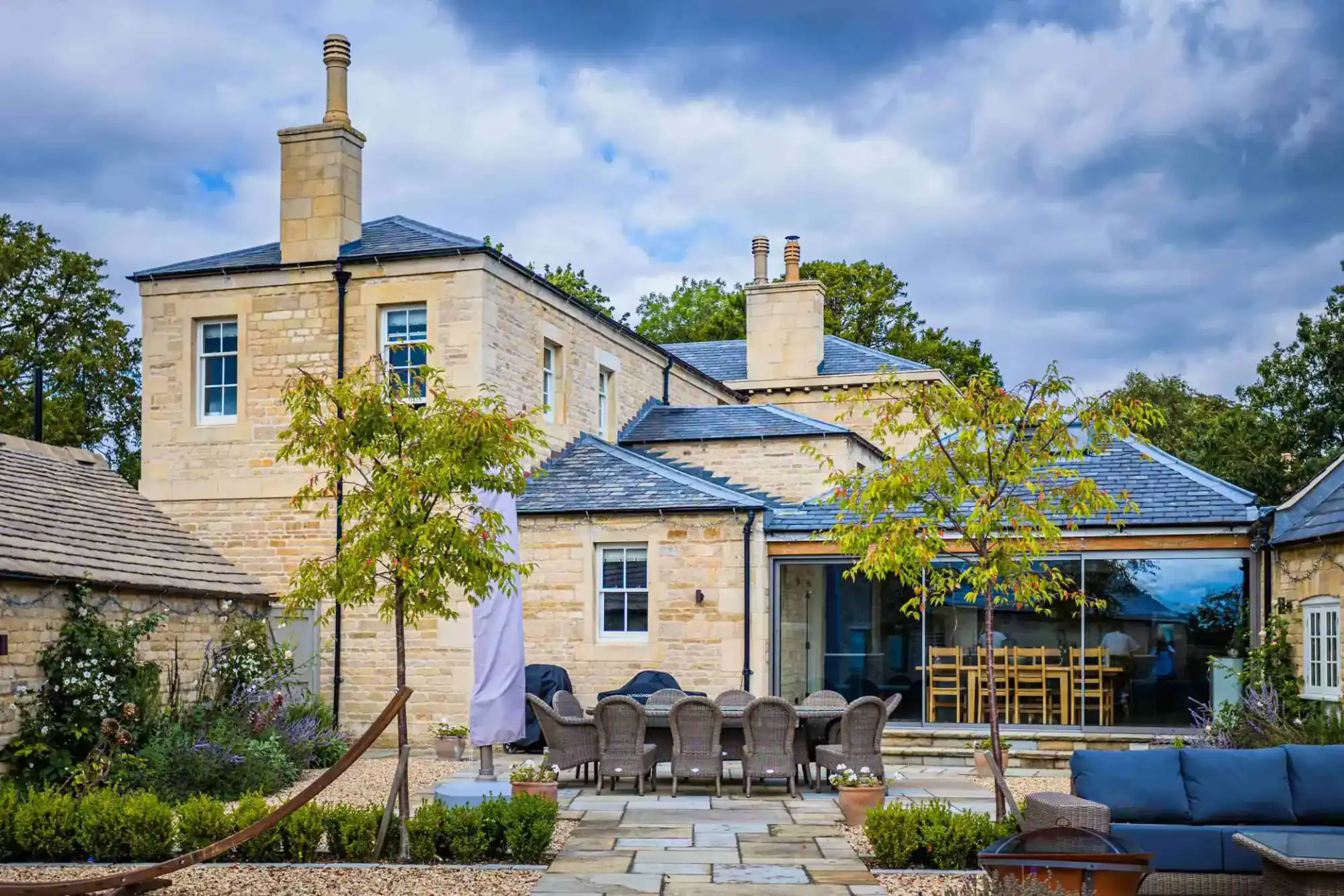 Greatford Manor, Lincolnshire: a stone house with a glazed extension onto the garden